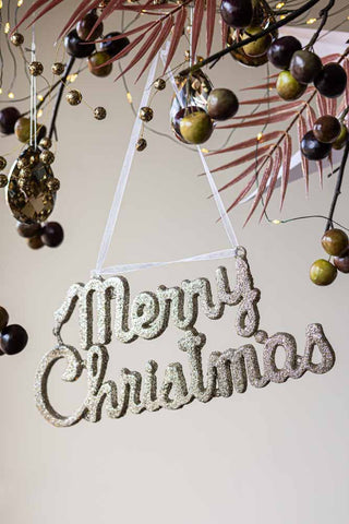 Lifestyle image of the Champagne Glitter Merry Christmas Decoration Sign