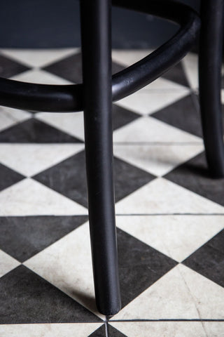 Image of the legs on the Chez Pitou Black Wood & Woven Cane Bar Stool