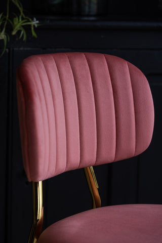 Close-up image of the Coral Pink Velvet Bar Stool With Gold Legs