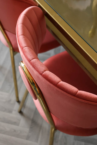 Close-up image of the Coral Pink Velvet Dining Chair With Gold Legs