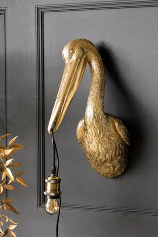 Lifestyle image of the Gold Crane Wall Light