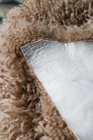 Image of the back of the Curly Sheepskin Rug In Butterscotch