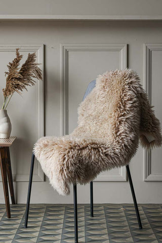 Image of the Curly Sheepskin Rug In Nappa on a chair