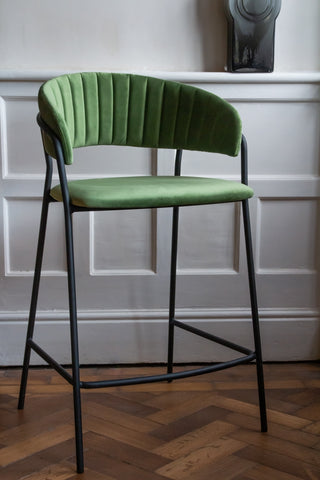 Lifestyle image of the Curved Back Velvet Bar Stool In Moss Green