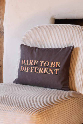Lifestyle image of the Dare To Be Different Embroidered Brown Cushion
