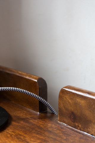 Close-up image of the cable gap on the Dark Mango Wood Bedside Table