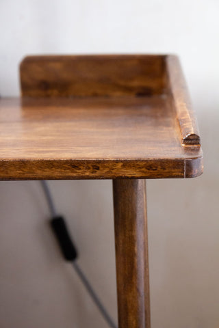 Close-up image of the wooden finish on the Dark Mango Wood Bedside Table With Cable Gap