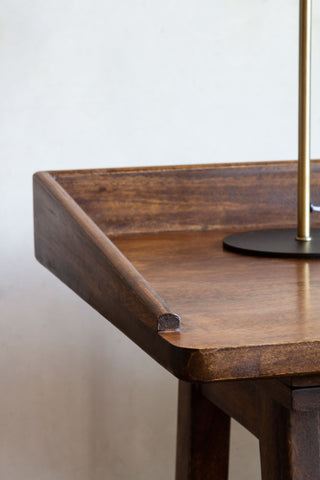 Close-up image of the side of the Dark Mango Wood Desk With Cable Gap