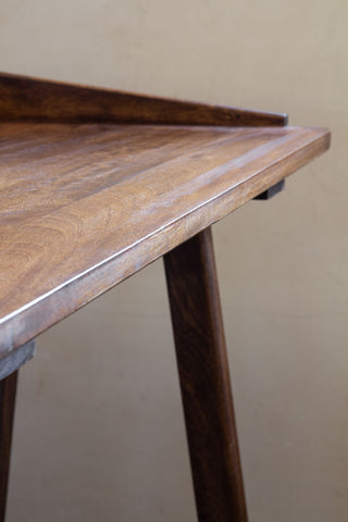 Close-up image of the front of the Dark Mango Wood Desk With Cable Gap