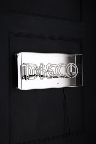 Image of the Disco Neon Light Box on a wall switched off with a mirrored backgroudn