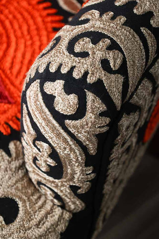 Close-up image of the arm on the Embroidered Folk Pattern Armchair