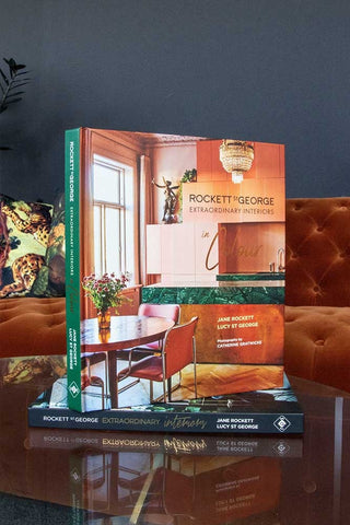 Lifestyle image of Extraordinary Interiors in Colour by Jane Rockett & Lucy St George standing up on the first book