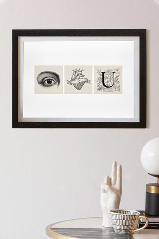 Lifestyle image of the Eye Heart You Art Print in a black frame