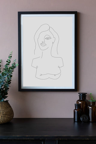 Close-up lifestyle image of the White Self Portrait Art Print hanging on a wall framed