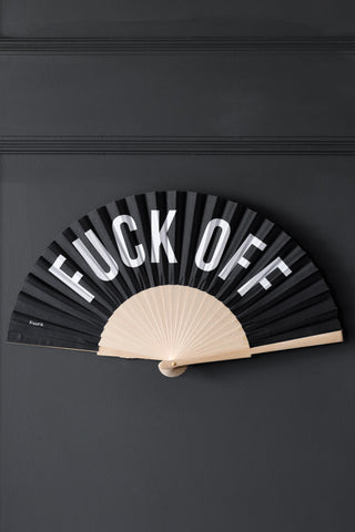 Lifestyle image of the Fuck Off Wooden Fan mounted onto a wall. 