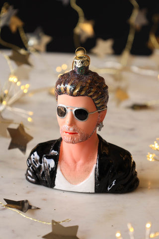 Image of the George Inspired Christmas Tree Decoration on a Christmas table. 