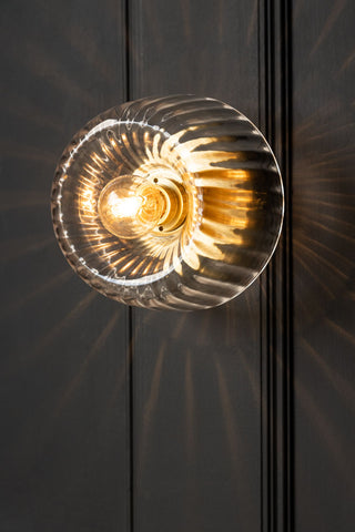 Lifestyle image of the Ribbed Glass & Brass Wall Light