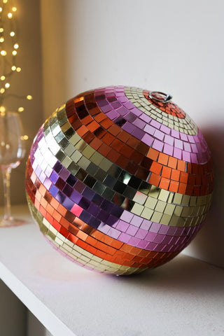 Image of the Gold & Pink Stripy Disco Ball sat on a shelf