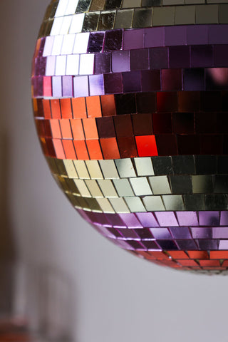 Close-up image of the Gold & Pink Stripy Disco Ball hanging