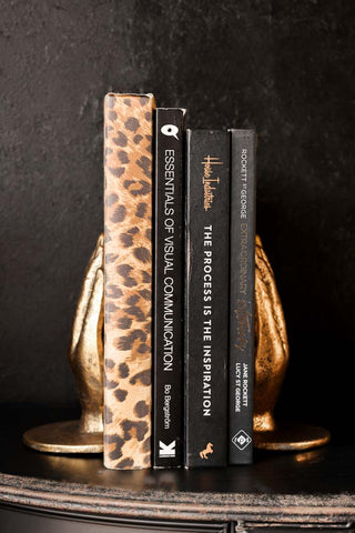 Lifestyle image of the Gold Holding Hands Bookends