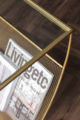 Close-up image of the Gold Magazine Rack With Glass Top