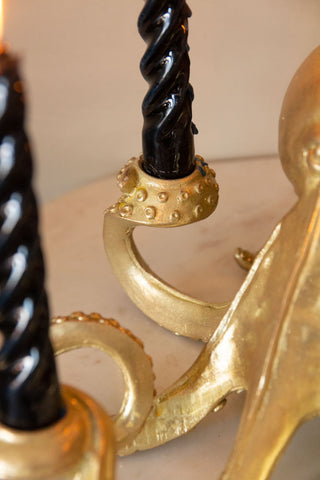 Detail image of gold octopus candlestick holder with black candles