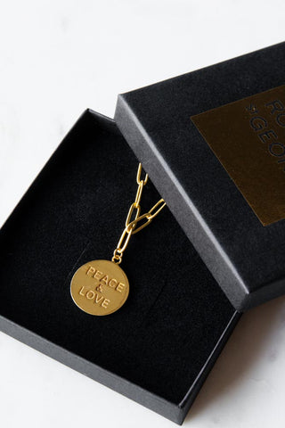 Lifestyle image of the Gold Peace & Love Coin Necklace