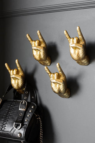 Lifestyle image of the Gold Set of 4 Rock On Wall Hands