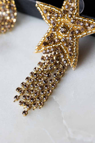 Close-up image of the Gold Shooting Star Beaded Earrings