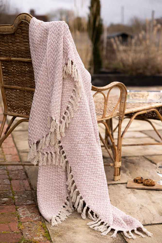 Lifestyle image of the Herringbone Pale Pink Cotton Throw