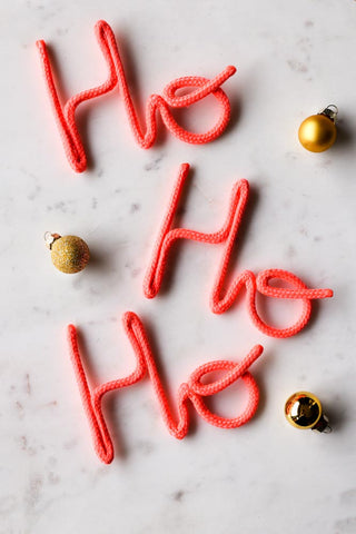 Lifestyle image of the Ho Ho Ho Coral Rope Sign Christmas Decoration