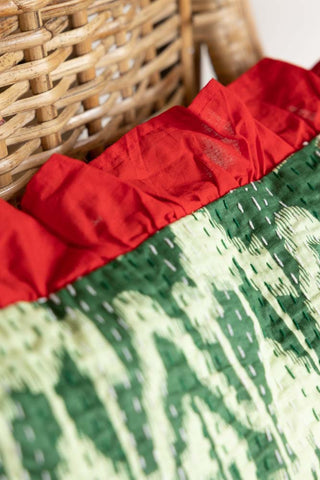 Close-up image of the Green Ikat & Red Frill Cotton Cushion