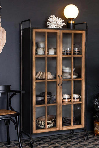 Lifestyle image of the Industrial Style Wooden Display Cabinet On Wheels with the doors closed
