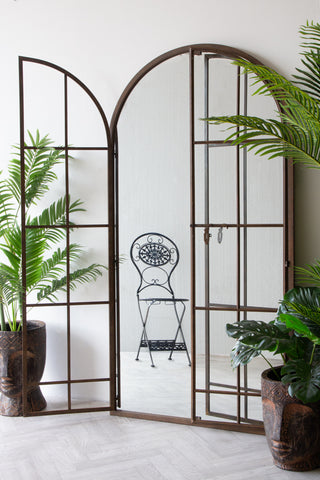 Lifestyle image of the Large Antique Metal Window Mirror With Opening Doors with the left door open