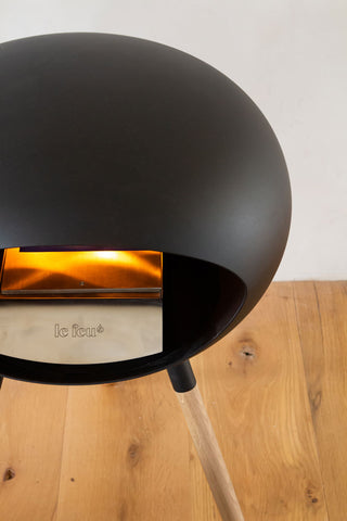 Image of the back of the Le Feu Ground Wood Eco Fireplace lit
