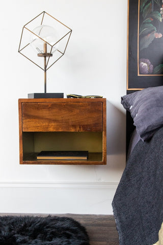Front-on lifestyle image of the Mango Wood Wall-Hung Bedside Shelf
