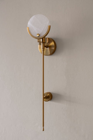 Angled image of the Marble Disc & Brass Wall Light on the wall