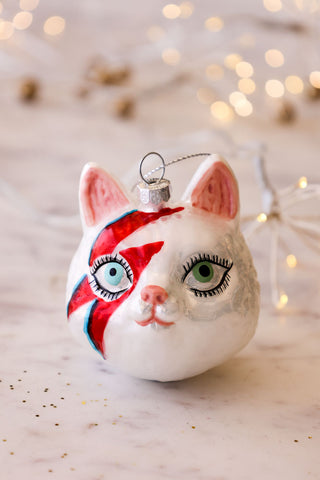 Image of the Meowie Bowie Christmas Tree Decoration on a Christmas table. 