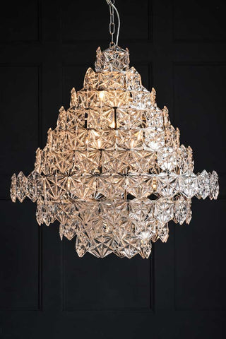 Image of the Showstopping Multi-Layer Glass Chandelier lit up on a dark background