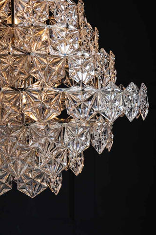 Close-up image of the pattern on the Showstopping Multi-Layer Glass Chandelier lit up
