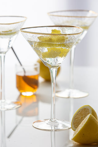 Lifestyle image of 3 of the Organic Cocktail Glasses With Gold Rim & other glasses