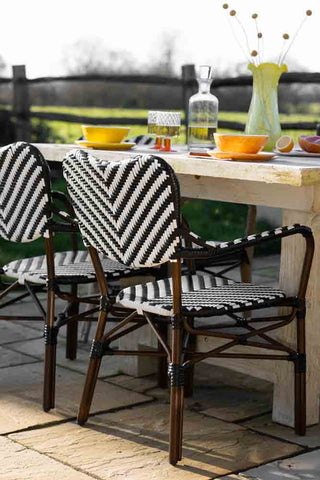 Lifestyle image of the Parisian Bistro Style Outdoor Dining Chair at a table outside