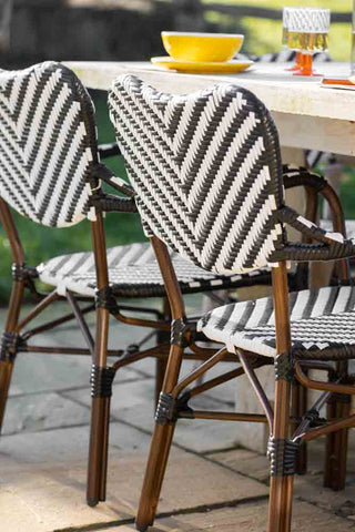 Lifestyle image of the Parisian Bistro Style Outdoor Dining Chair in the sun