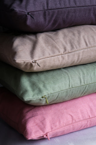 Image of all the cushions from the Embroidered text range stacked together