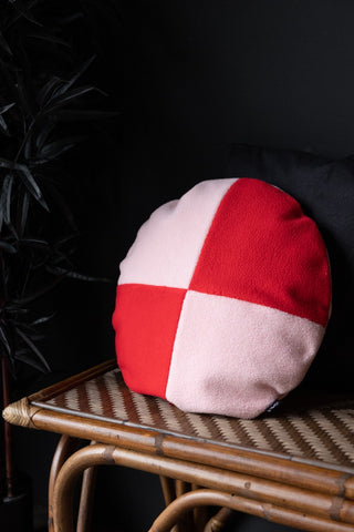 Lifestyle image of the Pink & Red Round Checkered Cushion