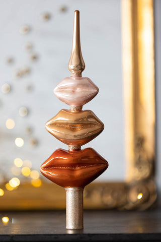 Lifestyle image of the Powdered Opal Lips Christmas Tree Topper