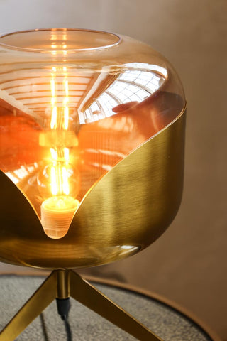 Close-up image of the Retro Golden Glass Tripod Table Lamp lit up