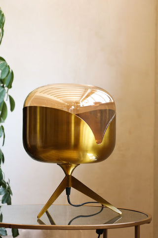Lifestyle image of the Retro Golden Glass Tripod Table Lamp