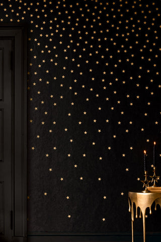 Lifestyle image of the Rockett St George Falling Stars Black Mural next to a door