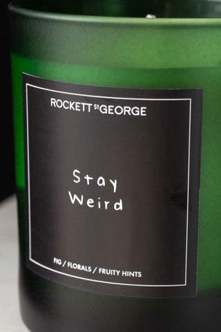 Detail image of the Rockett St George Green Stay Weird Scented Candle label